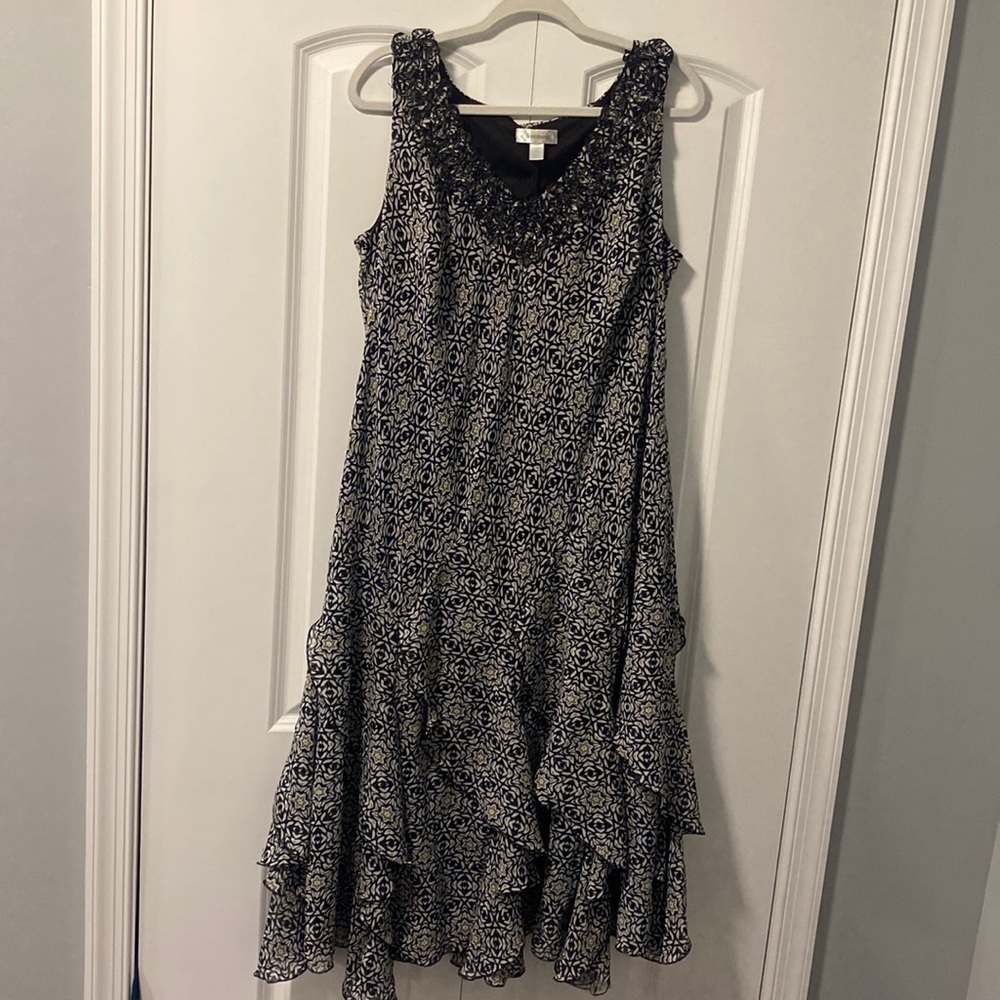 Black and white lined midi dress with stylish ruffles on the bottom and neckline